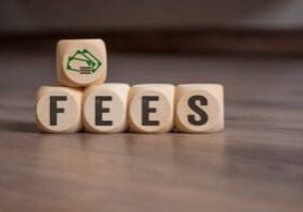 Cubes dice with fees on wooden background property management fees